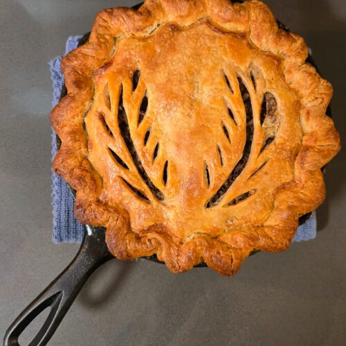 overhead photo of a golden baked tourtière from French-Canada