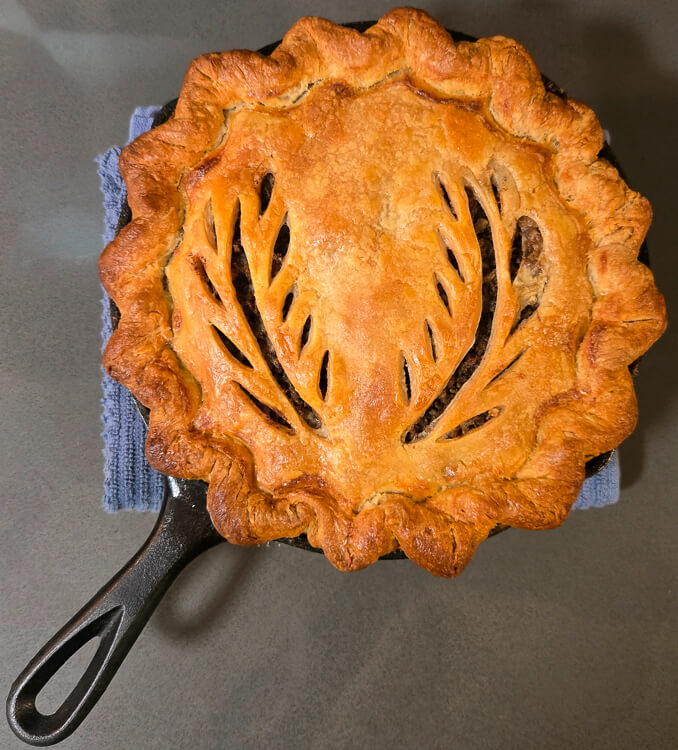 overhead photo of a golden baked tourtière from French-Canada