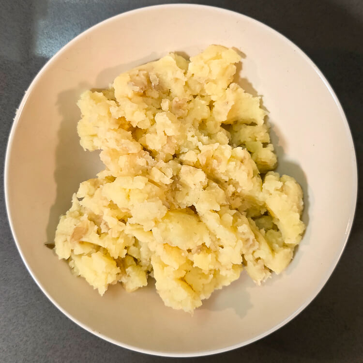 overhead photos of mashed potatoes in a white bowl