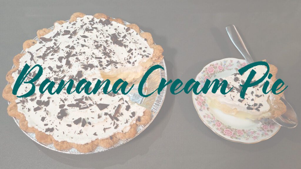 a photo of a banana cream pie topped with whipped cream and chocolate shavings with a slice cut out and placed next to it on a floral plate with text overlay that reads "banana cream pie"
