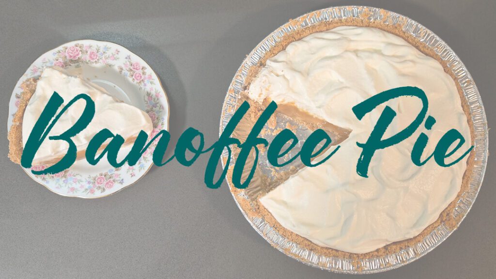 an overhead photo of a banoffee pie recipe topped with fluffy whipped cream with a slice cut out and placed next to it on a floral plate. There is a text overlay that reads "Banoffee Pie"