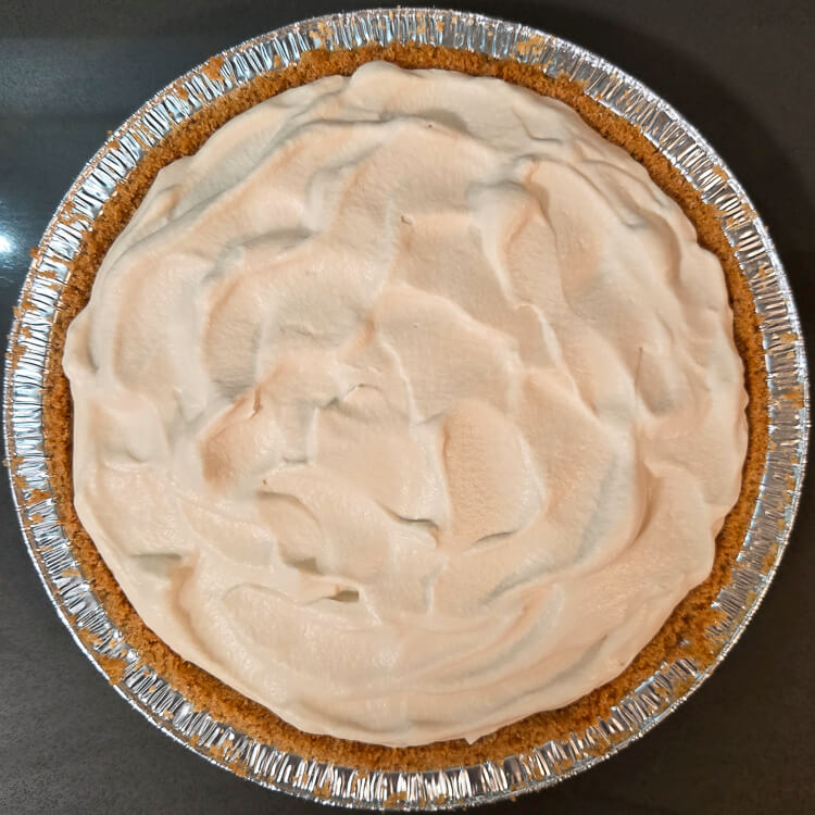 an overhead photo of a banoffee pie topped with whipped cream