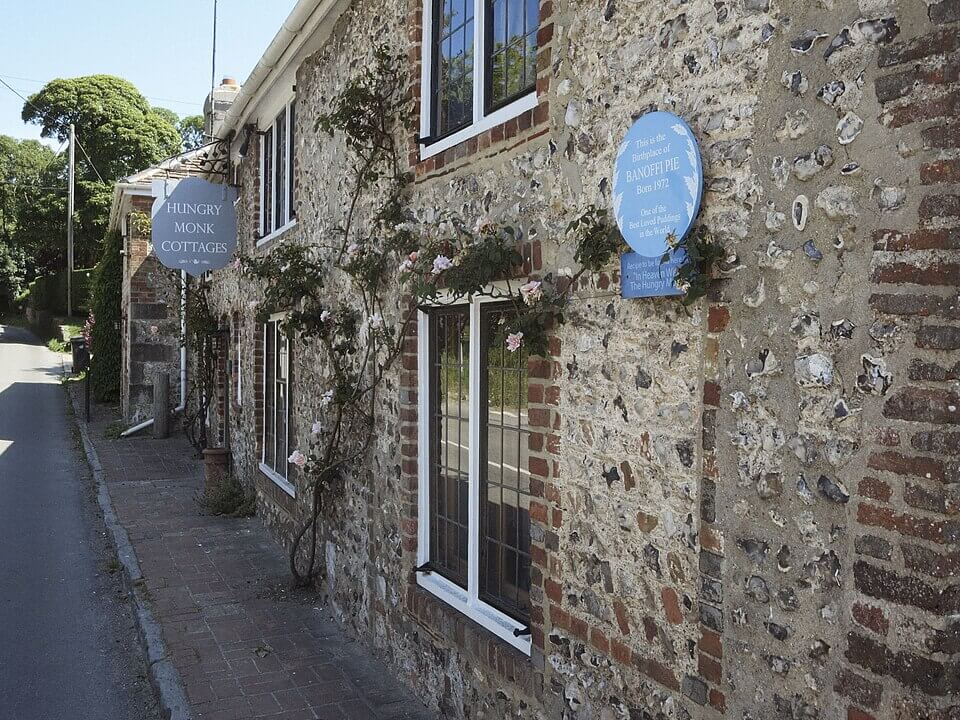 photo of The Hungry Monk restaurant with a sign showing that it is the birthplace of banoffi pie
