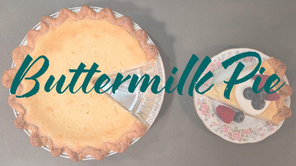 an overhead photo of a buttermilk pie recipe with a slice cut out and placed next to it on a floral plate served with whipped cream and fresh berries with a text overlay that reads "Buttermilk Pie"