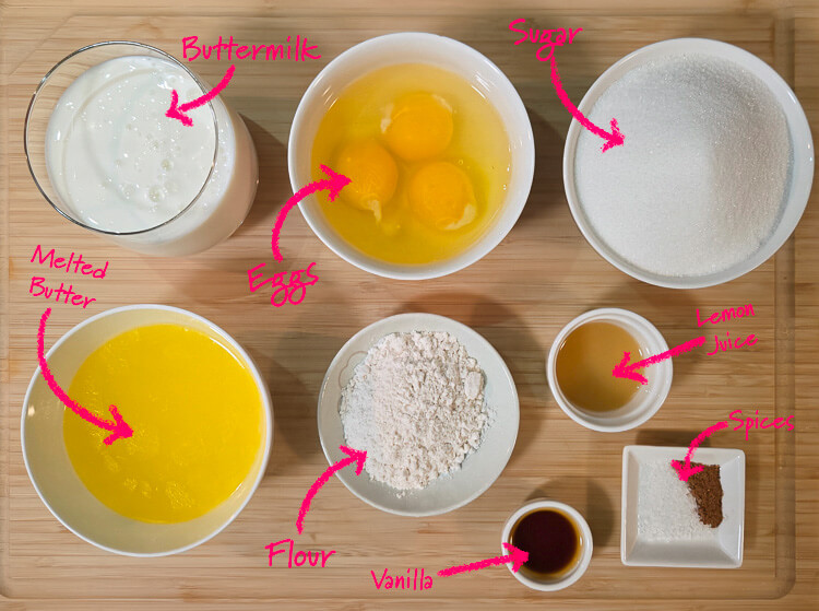 ingredients for buttermilk pie laid out on a cutting board with text labels: buttermilk, eggs, sugar, melted bttr, flour, vanilla, lemon juice, and spices