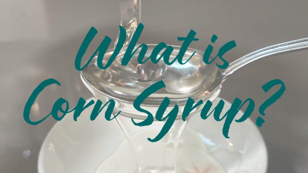 a close up photo of corn syrup being poured onto a spoon with text overlay that reads "What is corn syrup?"