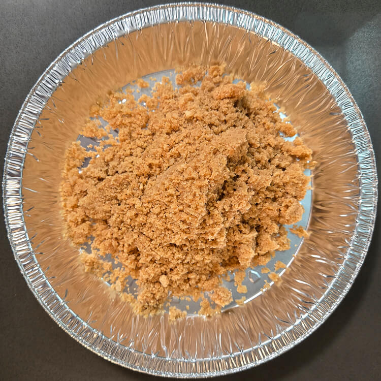 mixed digestive biscuit pie crust before being pressed into a pie tin