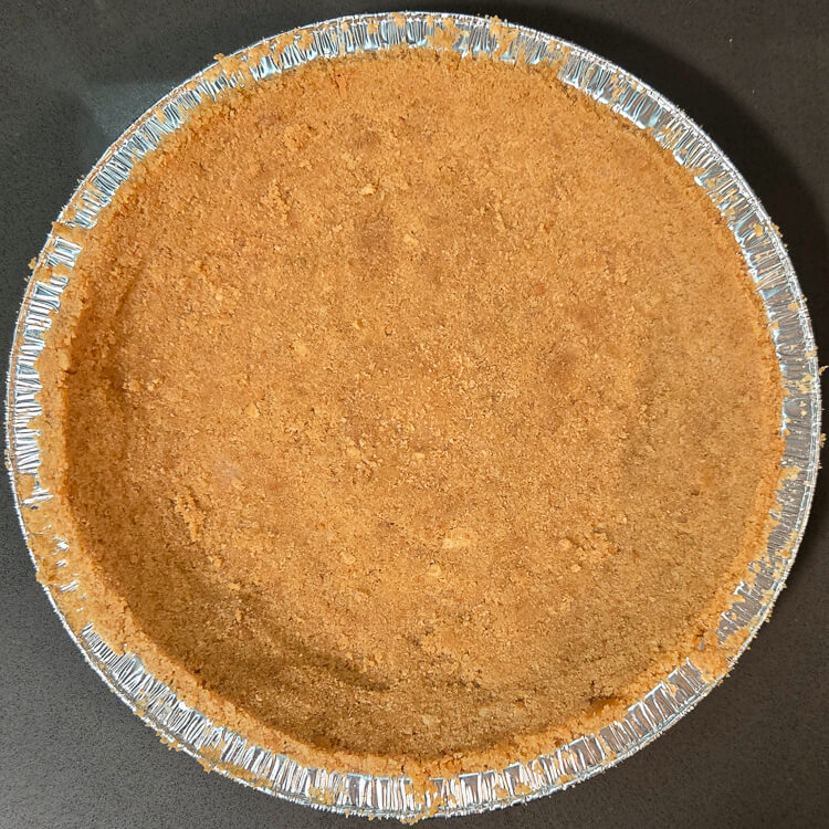 overhead photo of an unbaked digestive biscuit pie crust