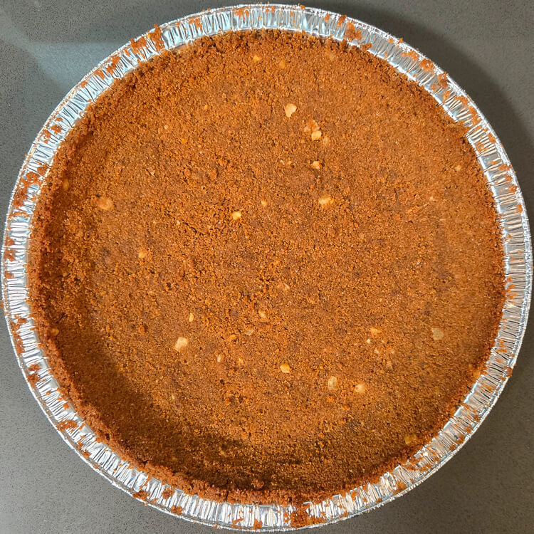 overhead photo of a crunchy, festive gingerbread pie crust before being filled with pie filling