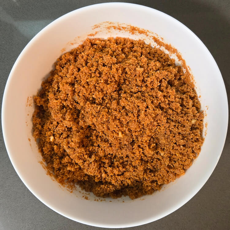 photo of freshly mixed gingerbread pie crust before it is pressed into a pie tin