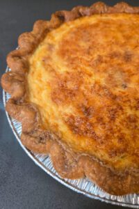 a close up photo of a golden baked quiche