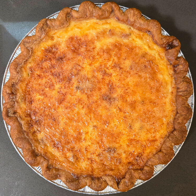 an overhead photo of a whole baked quiche lorraine
