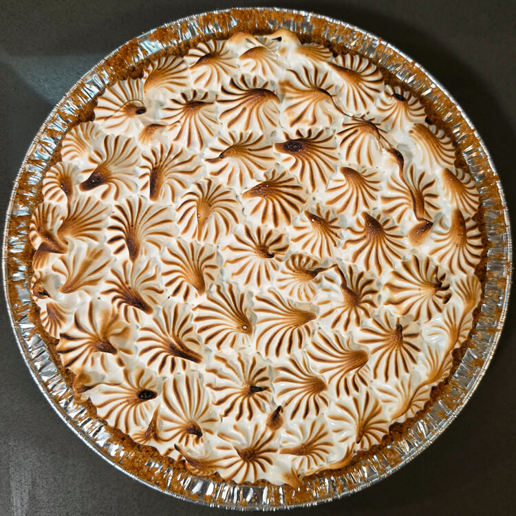 overhead photo of a flapper pie. Toasted piped meringue swirls cover the top of the pie