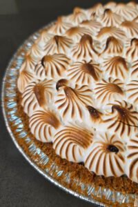 close up photo of a flapper pie recipe with piped meringue swirls