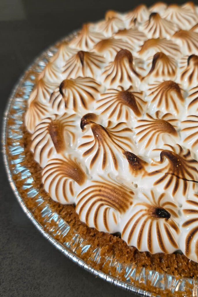 close up photo of a flapper pie recipe with piped meringue swirls