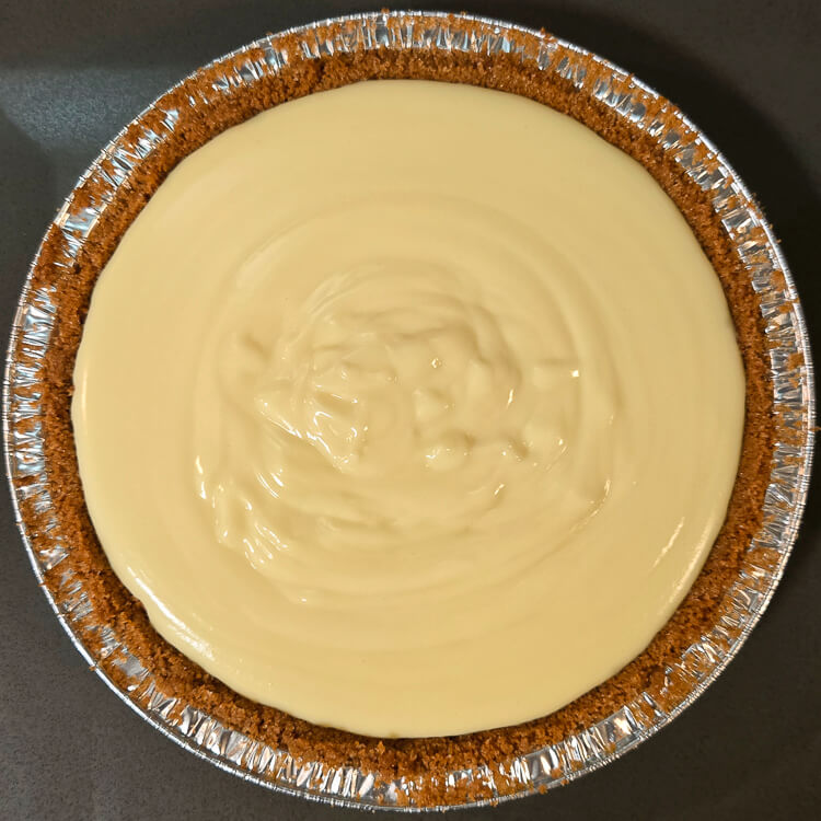 fresh homemade vanilla pudding poured into a graham cracker crust