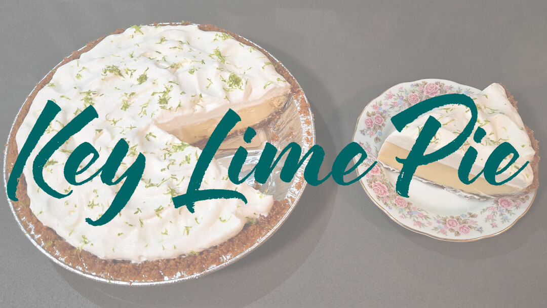 A photo of a key lime pie recipe with a slice cut out and placed next to it on an antique floral plate with text overlay that reads "Key Lime Pie"