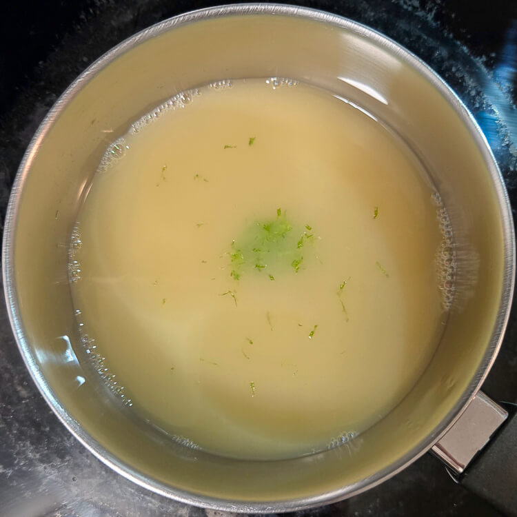 lime juice being heated with lime zest for stronger lime flavor