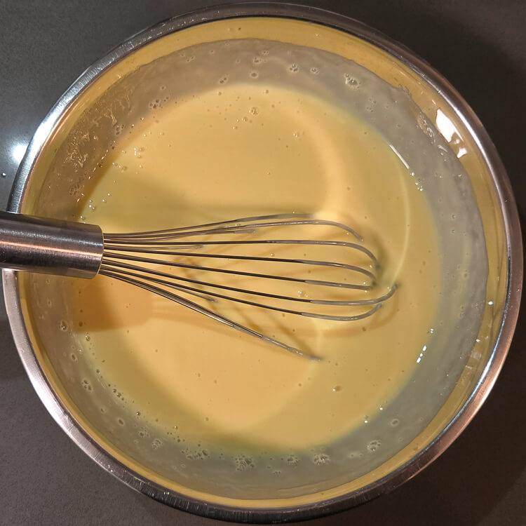 key lime pie filling in a mixing bowl with a metal whisk
