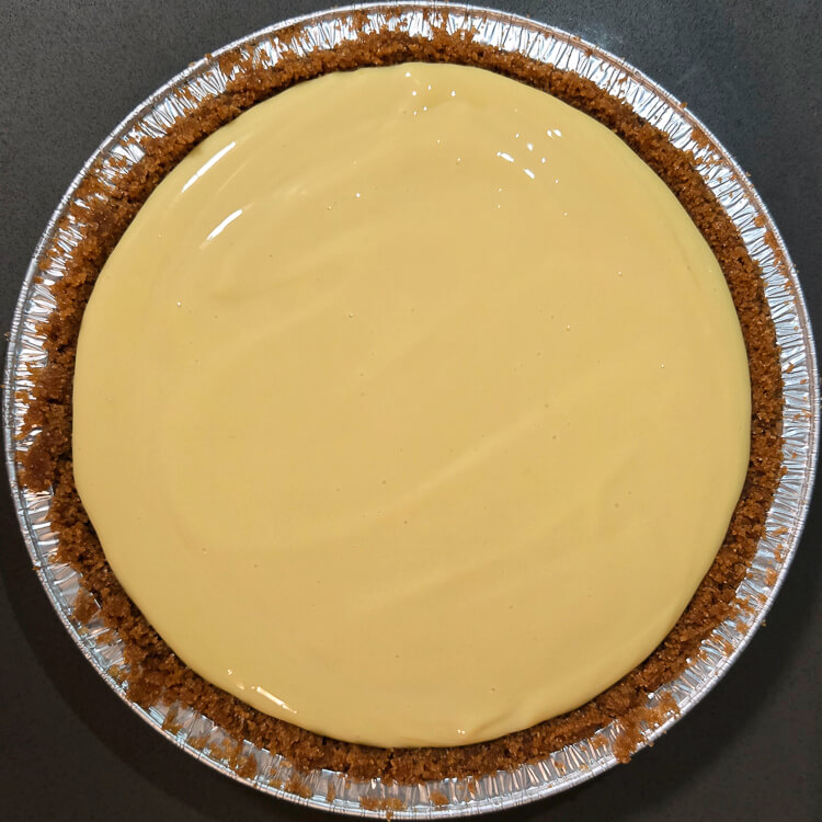 an overhead photo of a key lime pie before it is baked