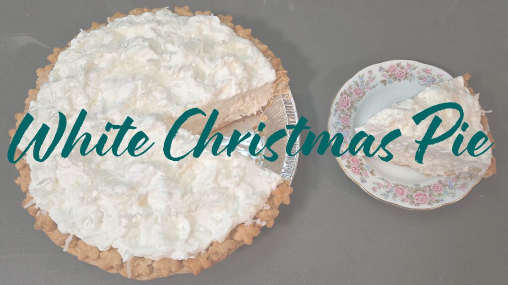 ingredients for white christmas pie laid out on a cutting board with text labels: milk, cream, water, gelatin, sugar, cream of tartar, salt, flour, vanilla, coconut, egg whites with text overlay that reads "White Christmas Pie"
