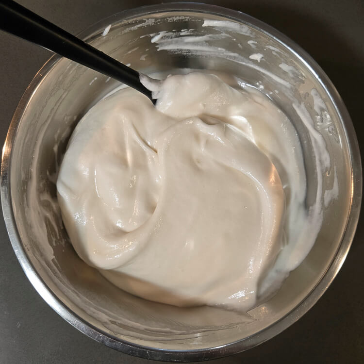 chiffon pie filling being mixed. Folding meringue into white christmas pie filling