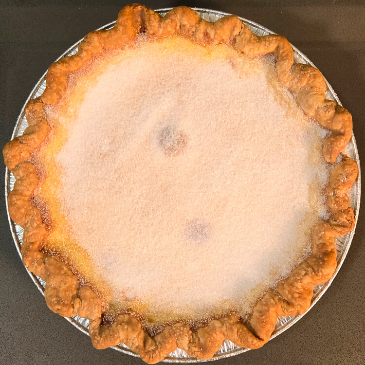 an overhead photo of a crème brûlée pie before brûlée-ing a layer of sugar on top