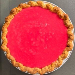 an overhead photo of cranberry curd that has been freshly made and poured into a pie shell