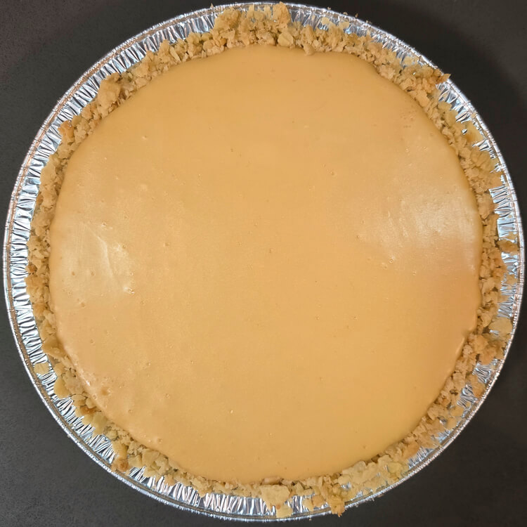 an atlantic beach pie after baking before being topped with whipped cream so you can clearly see the baked citrus custard filling in a saltine cracker crust