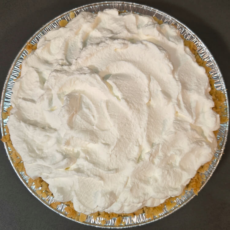 overhead photo of an atlantic beach pie in a saltine cracker crust topped with whipped cream