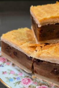 Chester cake photo up close showing 3 pieces of gur cake with gooey filling and flakey crust