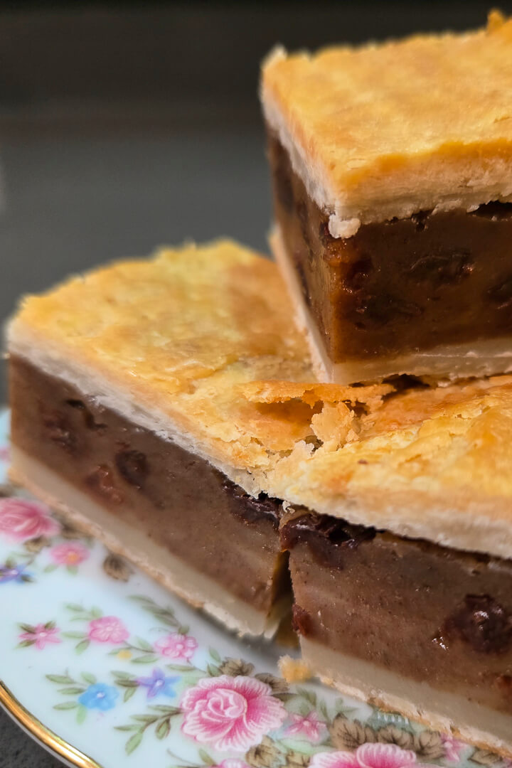 Chester cake photo up close showing 3 pieces of gur cake with gooey filling and flakey crust