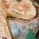 photo of a whole eggnog cream pie in a gingersnap crust with festive Christmas graphics with text overlay that reads "eggnog cream pie"