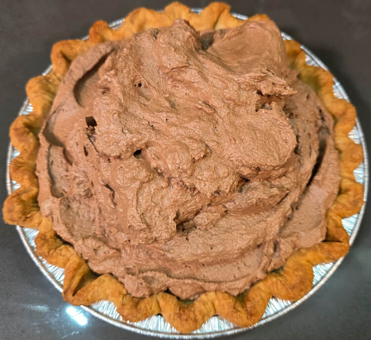chocolate mousse piled high into a golden crimped pie crust before smoothing and shaping