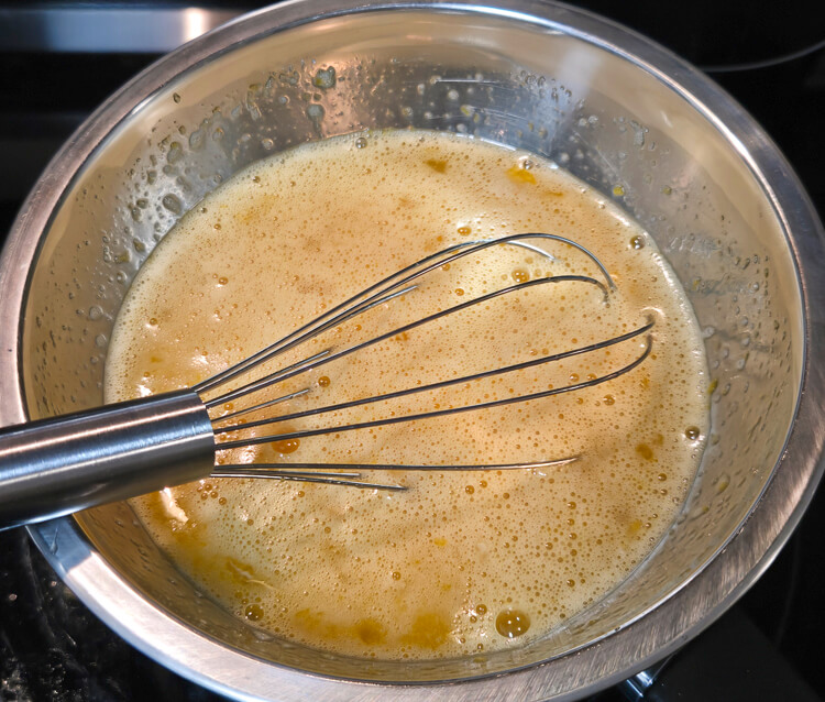 eggs and sugar being mixed together on a stove top to pasteurize the eggs to 165F