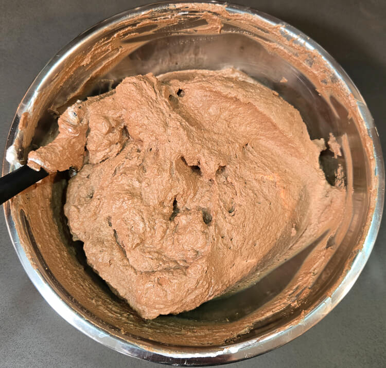 chocolate mousse mixed in a metal mixing bowl after folding whipped cream gently into a chocolate and egg mixture