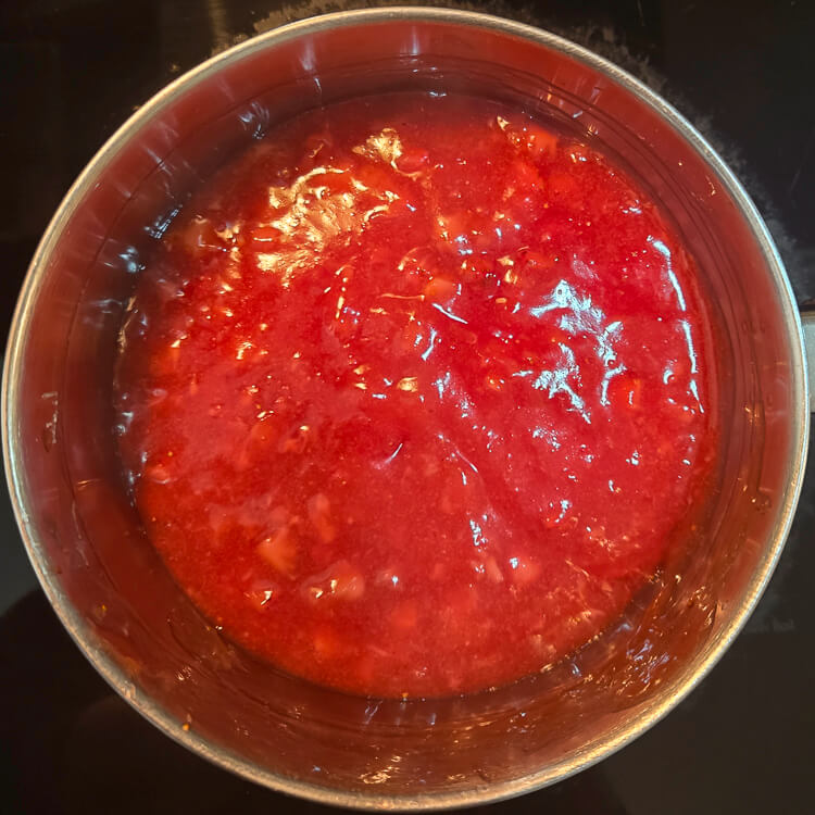 overhead photo of deep red strawberry glaze cooked on the stovetop