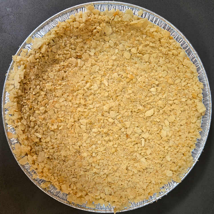 a saltine cracker pie crust in a metal pie tin