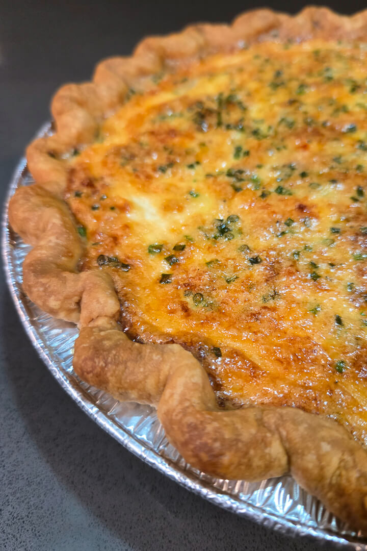 a close up photo of a loaded baked potato quiche