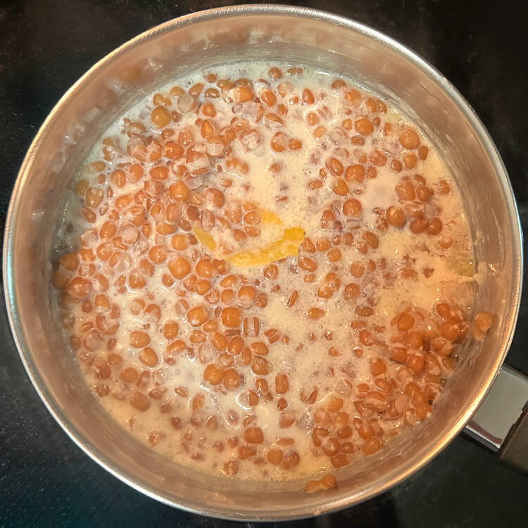 wheat berries being boiled with citrus peels and milk for the filling of an Italian Easter pie