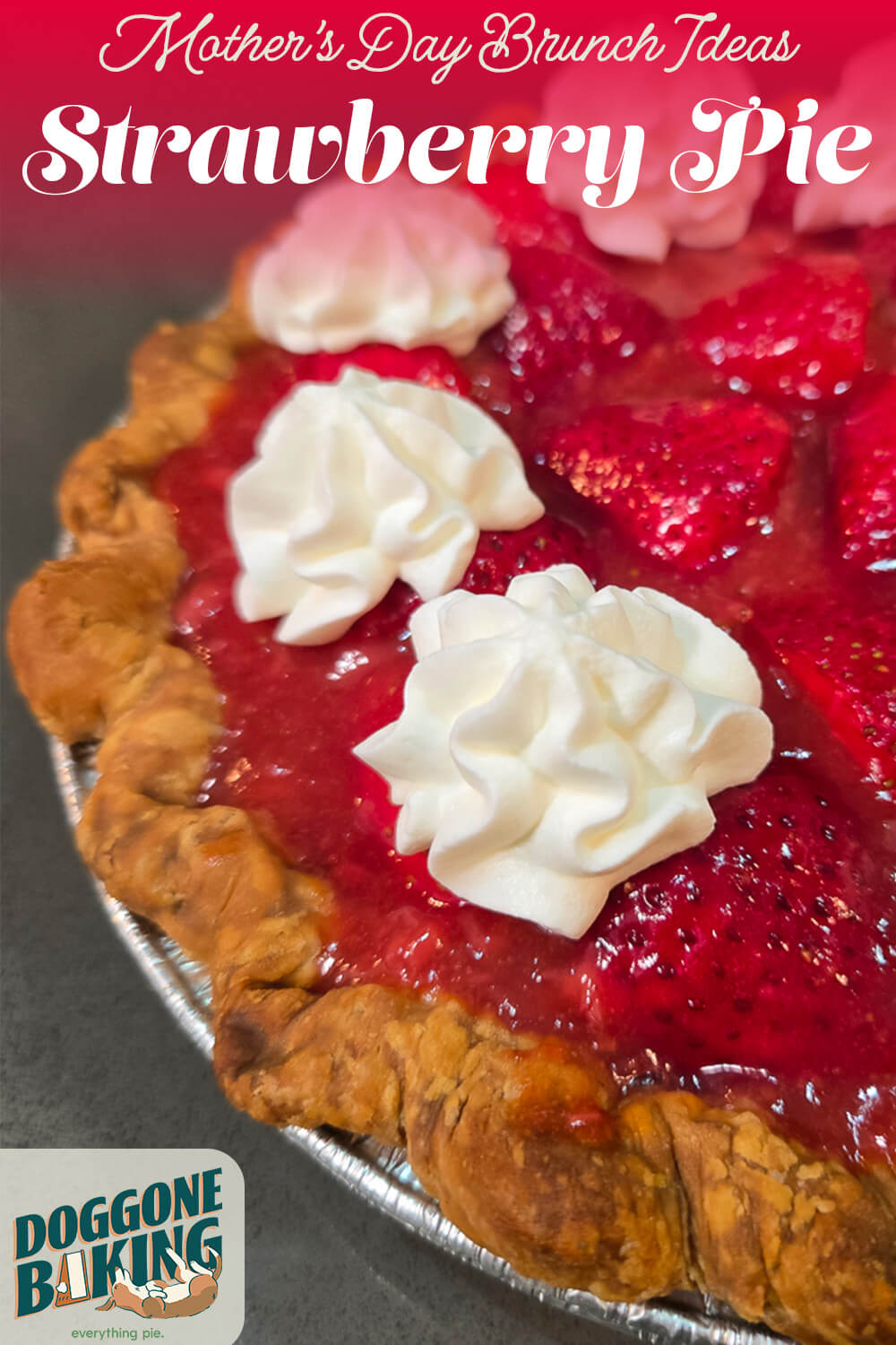 Angled overhead close-up of a fresh strawberry pie with glossy red strawberry glaze and three piped whipped cream rosettes in a crimped pastry crust, with a pink and red text banner at the top reading "Mother's Day Brunch Ideas — Strawberry Pie" and the Doggone Baking logo in the bottom left corner.