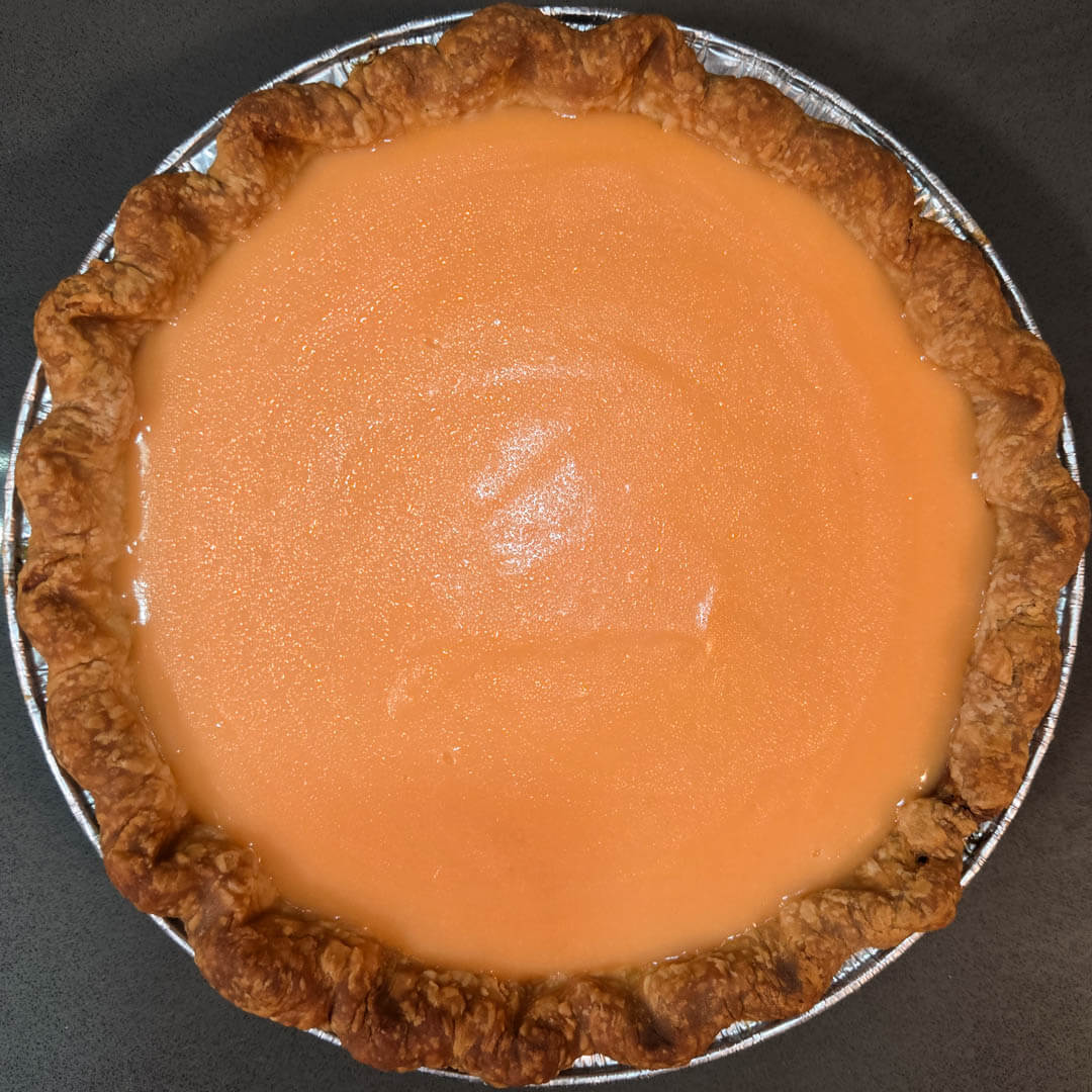 chilled grapefruit curd set in a flaky pie crust with crimped edges