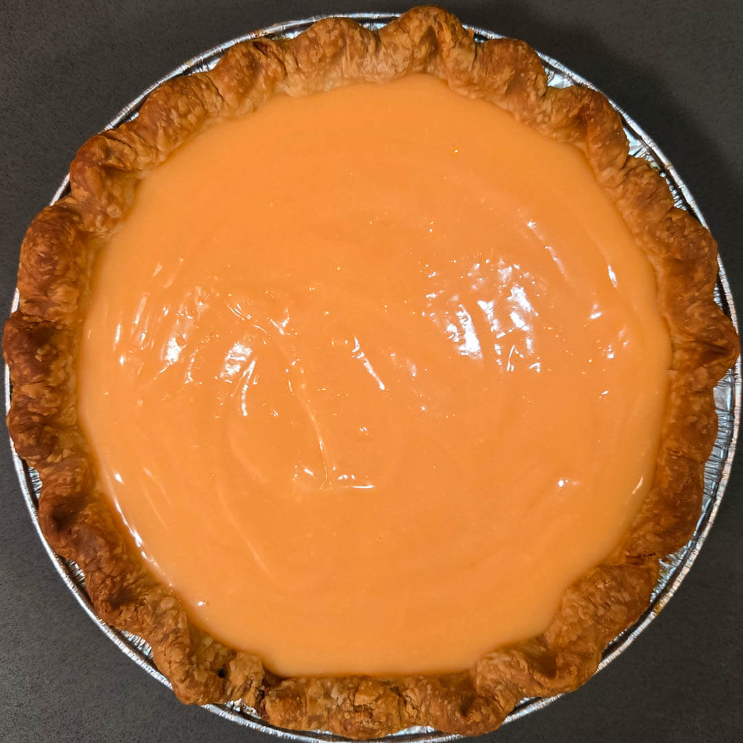 fresh grapefruit curd poured into a flaky pie crust with crimped edges