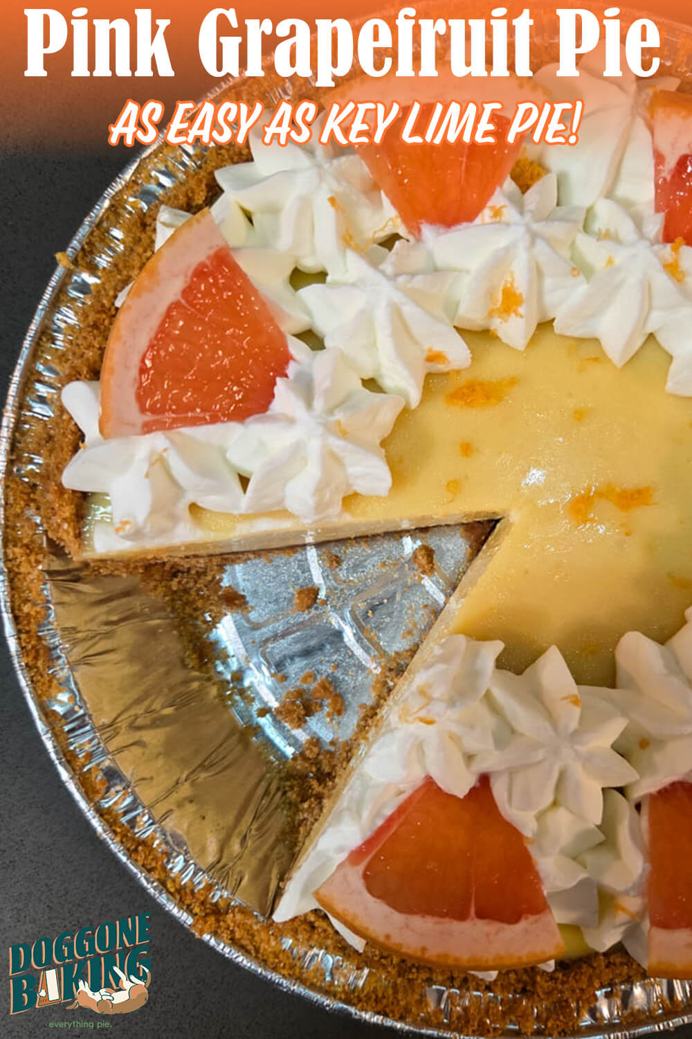 Pink grapefruit pie overhead photo in an aluminum pie tin. The icebox pie is decorated with whorls of fresh whipped cream, grapefruit zest, and slices of grapefruit. Text overlay reads "Pink Grapefruit Pie, As Easy as Key Lime Pie!" with the Doggone Baking logo in the corner