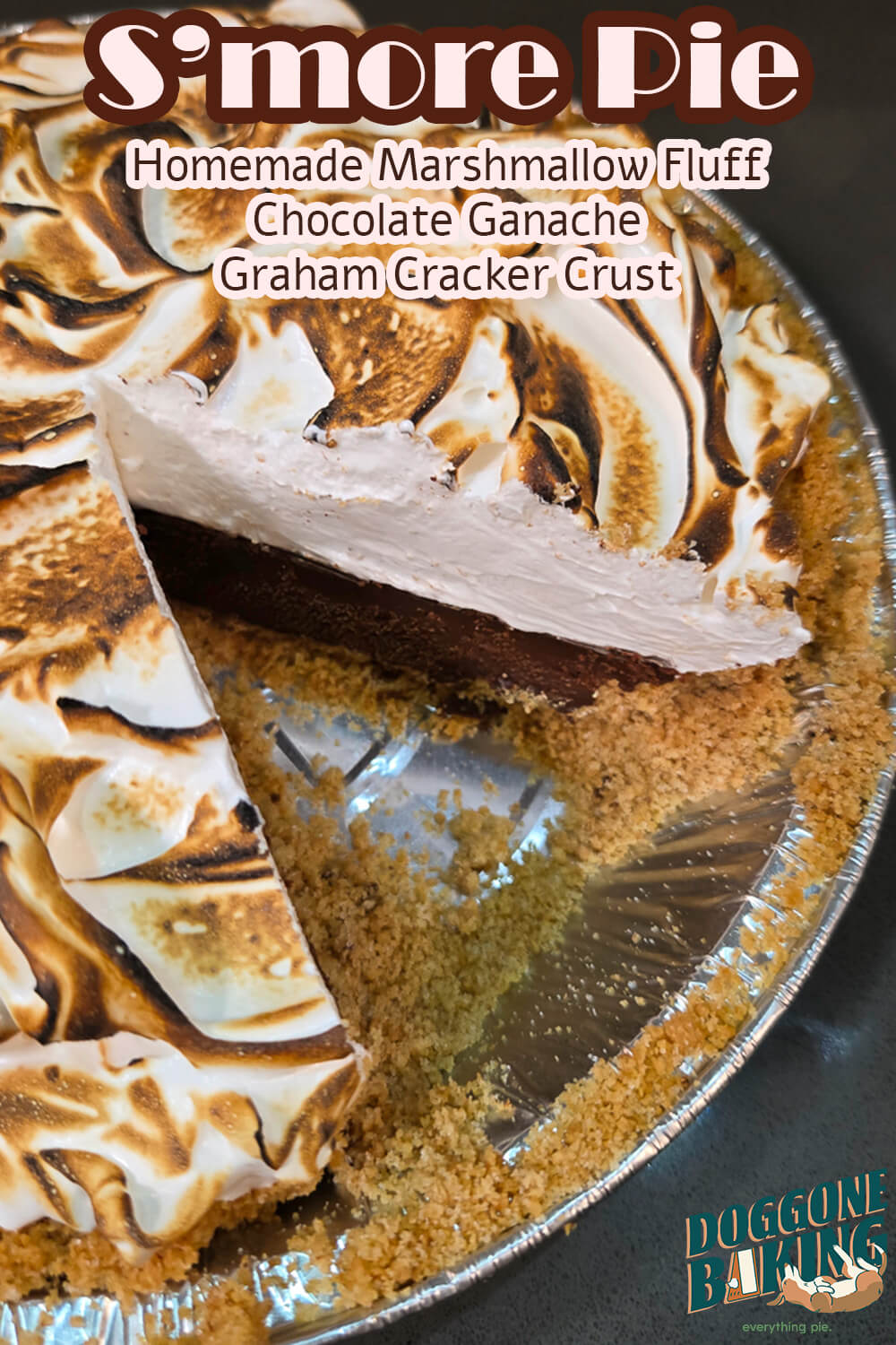 A Pinterest pin for an s'mores pie recipe. The image shows a close-up angled view of a s'mores pie with a slice removed, revealing a dark chocolate ganache filling, a graham cracker crust, and a tall toasted marshmallow fluff topping with golden brown char marks, with the Doggone Baking logo in the bottom right corner. Text overlay reads "S'more Pie | Homemade Marshmallow Fluff | Chocolate Ganache | Graham Cracker Crust."