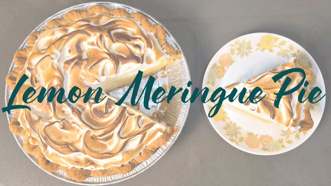 lemon meringue pie recipe header image showing a lemon meringue pie with a slice cut out and placed next to the pie with text overlay that reads "lemon meringue pie"