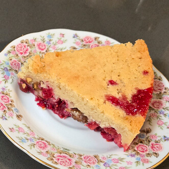 a slice of Nantucket cranberry pie, or cranberry upside down cake on an antique floral plate