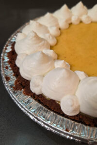 passionfruit pie (also called pie de maracuyá, torta de maracujá, or granadilla pie depending on where you live) with tangy passionfruit custard in a biscoff pie crust topped with freshly whipped cream